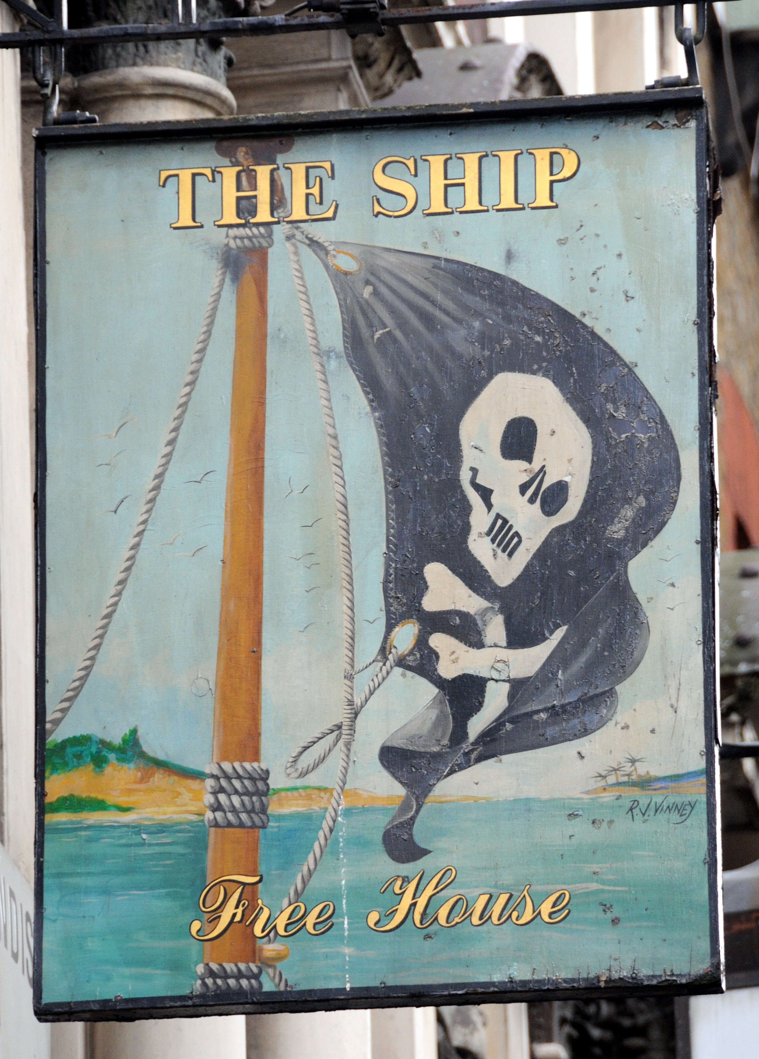 Pub sign showing skull and cross bones pirate flag.