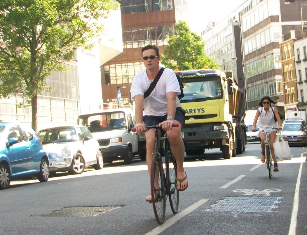 Man and woman cycling along New Cavendish Street