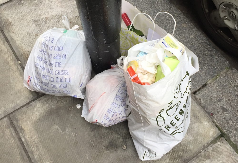 Refuse in bags on pavement.