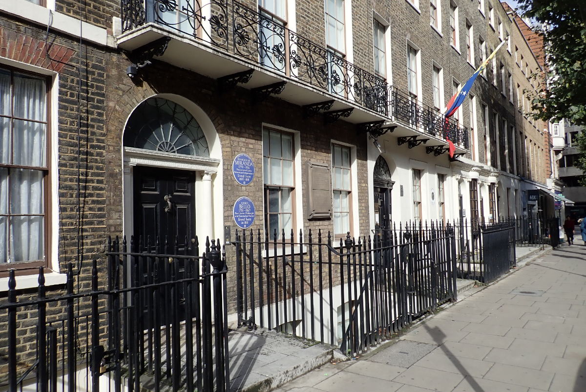 Row of buildings showing blue plaques.