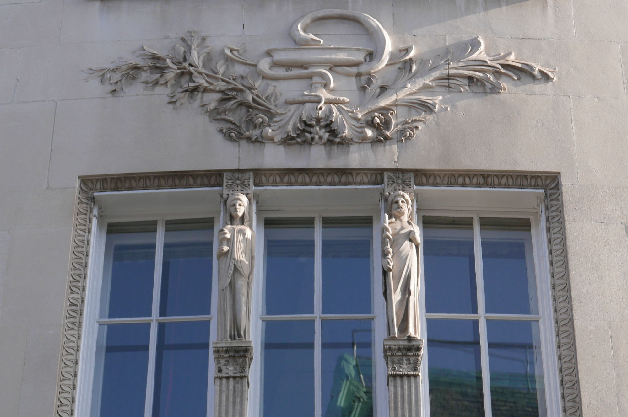 Statues and carving on front of building.