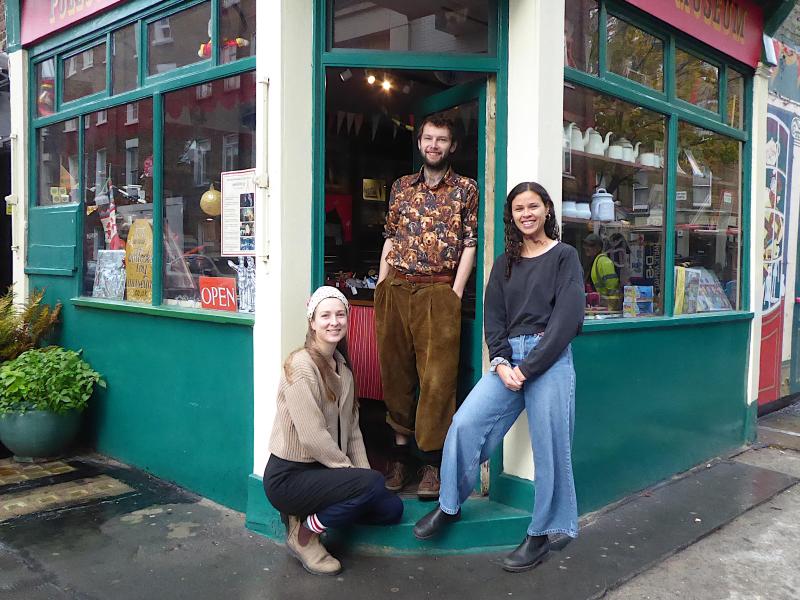 Three members of staff outside Pollock's Toy Museum and Shop.